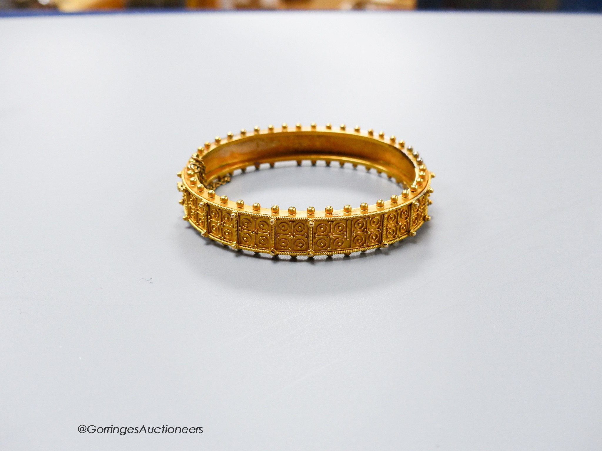 A cased Victorian yellow metal cannetile work hinged bracelet, inner diameter 55mm, 19.1 grams(a.f.).